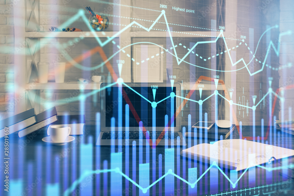Financial chart drawing and table with computer on background. Double exposure. Concept of international markets. Financial chart drawing and table with computer on background. Double exposure. Concept of international markets.