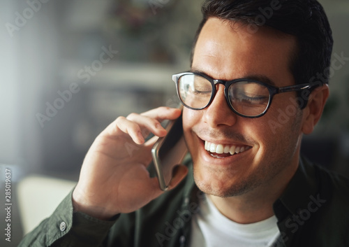 Man smiling while talking on the mobile phone photo