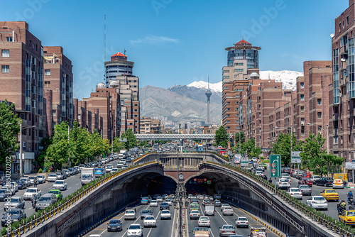 Obraz na płótnie 06/05/2019 Tehran,Iran,Famous view of Tehran,Flow of traffic inside, above and nearby round Tohid Tunnel with Milad Tower and Alborz Mountains in Background w salonie