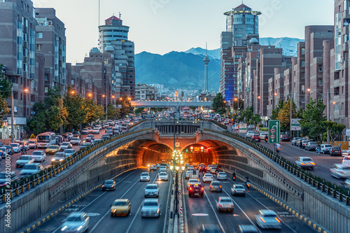 06/05/2019 Tehran,Iran,Famous night view of Tehran,Flow of traffic round Tohid Tunnel with Milad Tower and Alborz Mountains in Background, Tohid Tunnel one of longest urban tunnel in Middle East