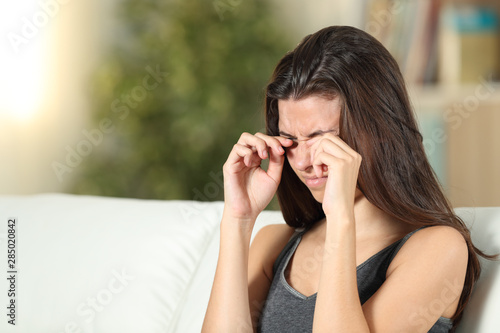 Girl suffering itching scratching eyes at home