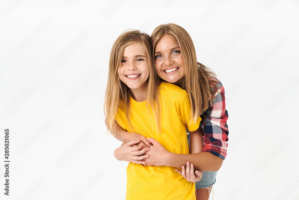 Photo of young caucasian family mother and daughter smiling and hugging together at camera Photo of young caucasian family mother and daughter smiling and hugging together at camera
