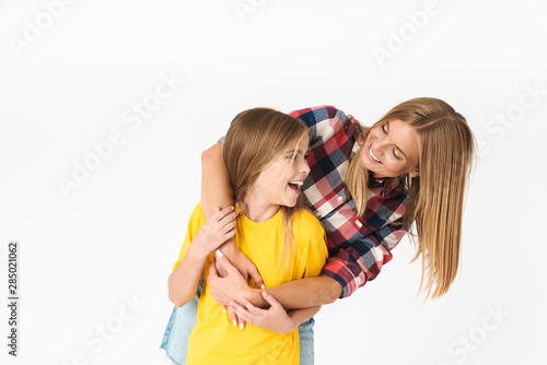 Photo of happy caucasian family mother and daughter smiling and hugging together at camera