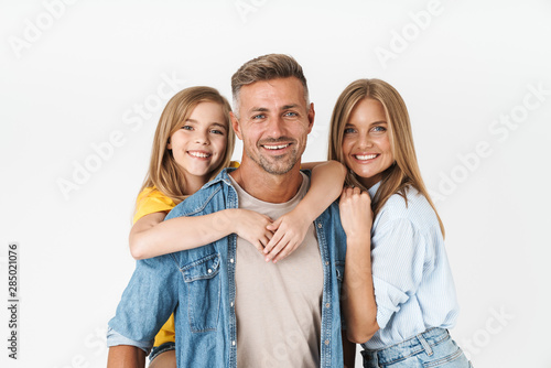 Photo of adorable caucasian family woman and man with little girl smiling and posing together at camera