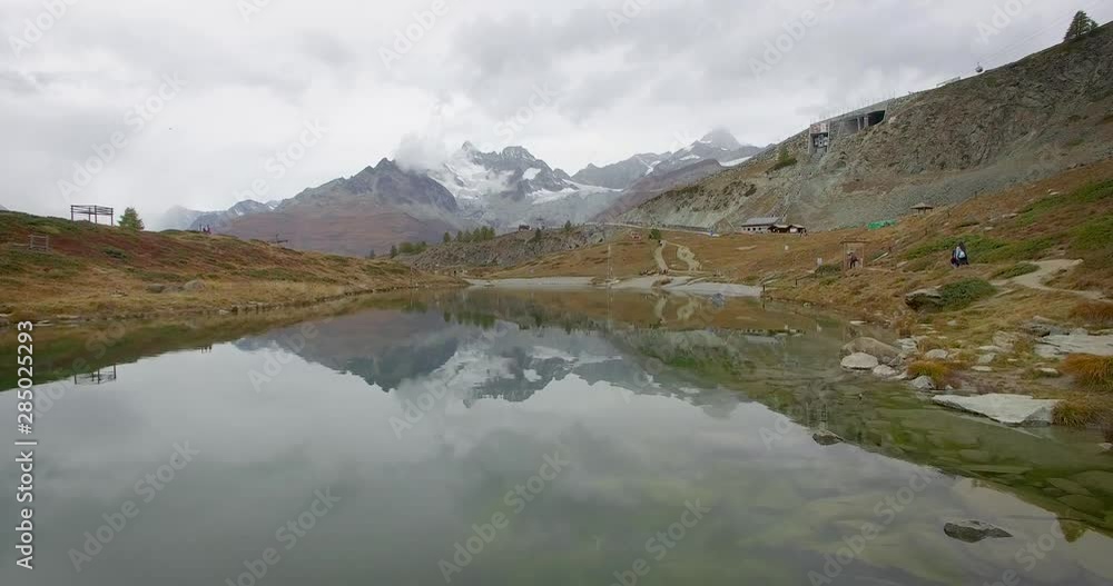 Low flight over Stellisee lake with mountain Matterhorn view near Zermatt Low flight over Stellisee lake with mountain Matterhorn view near Zermatt