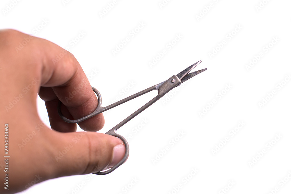 scissors in a hand isolated on white background scissors in a hand isolated on white background