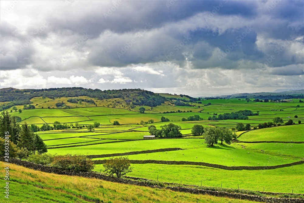 Rain clouds gather over Austwick meadowland, Yorkshire Dales, England