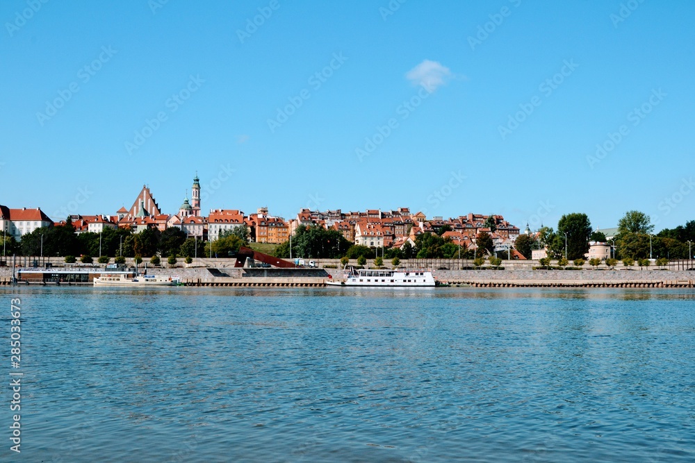 View of the Old Town and Vistula river. Historic quarter of Warsaw with Royal Castle and red roof tenements. Warsaw, Poland