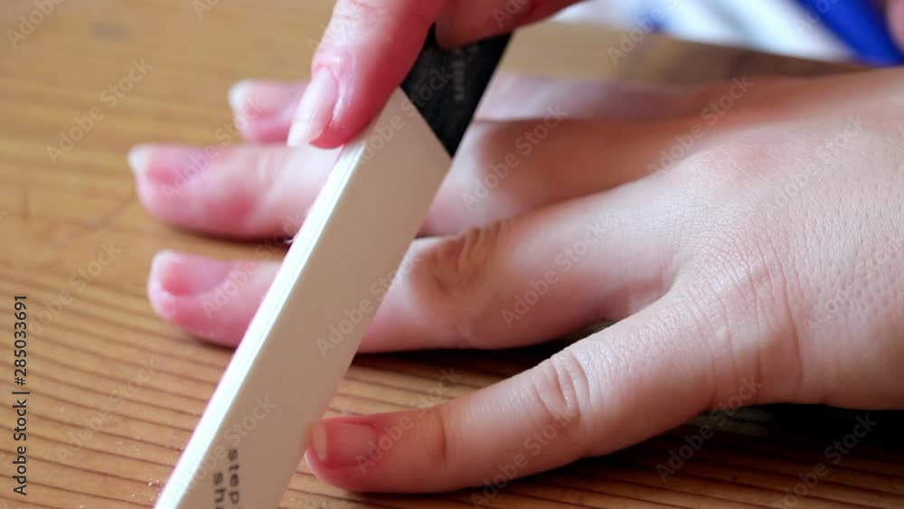 Hand Manicure, Close Up Female Hands Using Nail File. Hand Manicure, Close Up Female Hands Using Nail File.