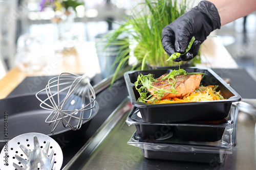 Catering. Meal prep.The cook prepares take-out dishes.