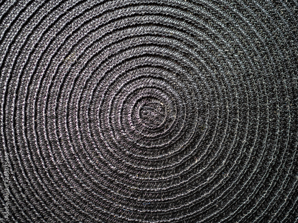 Fototapeta premium Black abstract woven surface with spiral circles