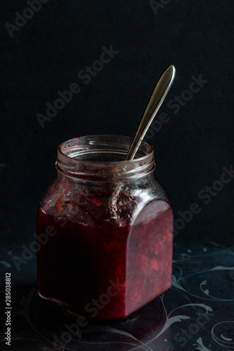 jam in a jar, tea and cake on a dark background