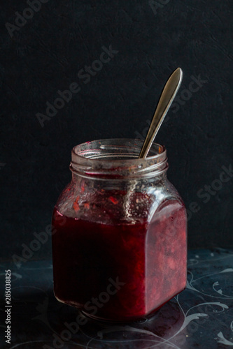 jam in a jar, tea and cake on a dark background