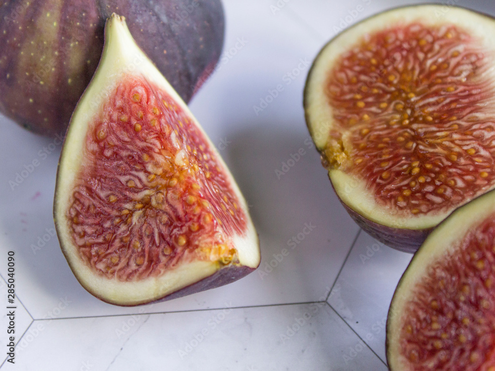 ripe figs with a knife on a marble table ripe figs with a knife on a marble table