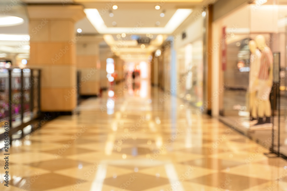 Obraz premium Luxury department store shopping mall interior, abstract defocused blur with bokeh background, concept of shopping seasons design.