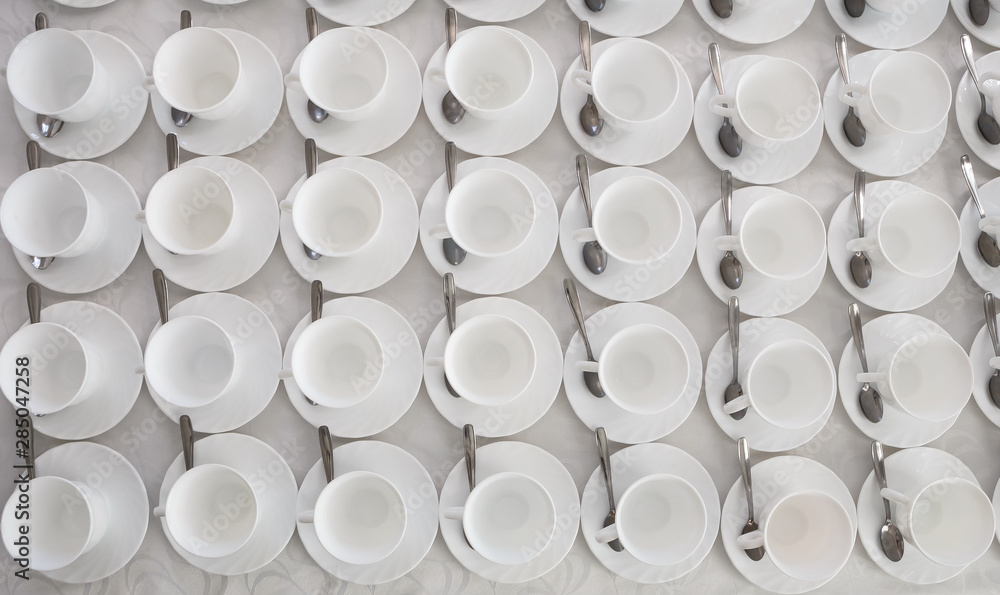 empty white coffee tea cups in rows on the table empty white coffee tea cups in rows on the table