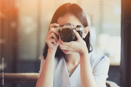 Photos Asian girl taking photo by  SLR Film camera