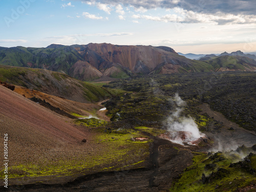 Colorful Rhyolit mountain panorma with multicolored volcanos and geothermal fumarole and in Landmannalaugar area of Fjallabak Nature Reserve in Highlands region of Iceland
