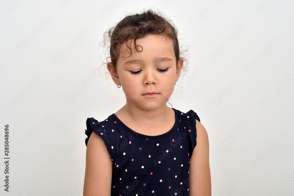Portrait of a sad and unhappy young girl looking down Portrait of a sad and unhappy young girl looking down