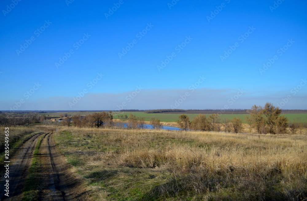 Country road and river in the steppe