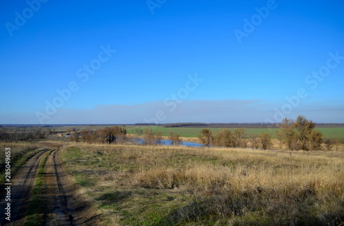 Country road and river in the steppe