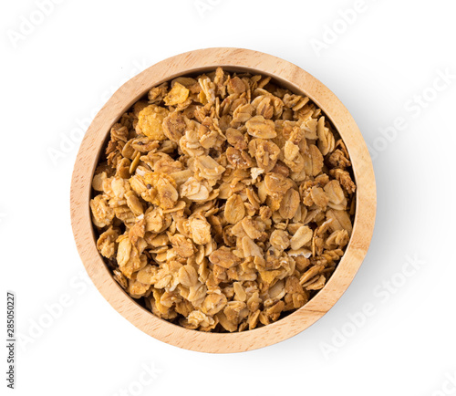 Granola in wood bowl isolated on white background. top view