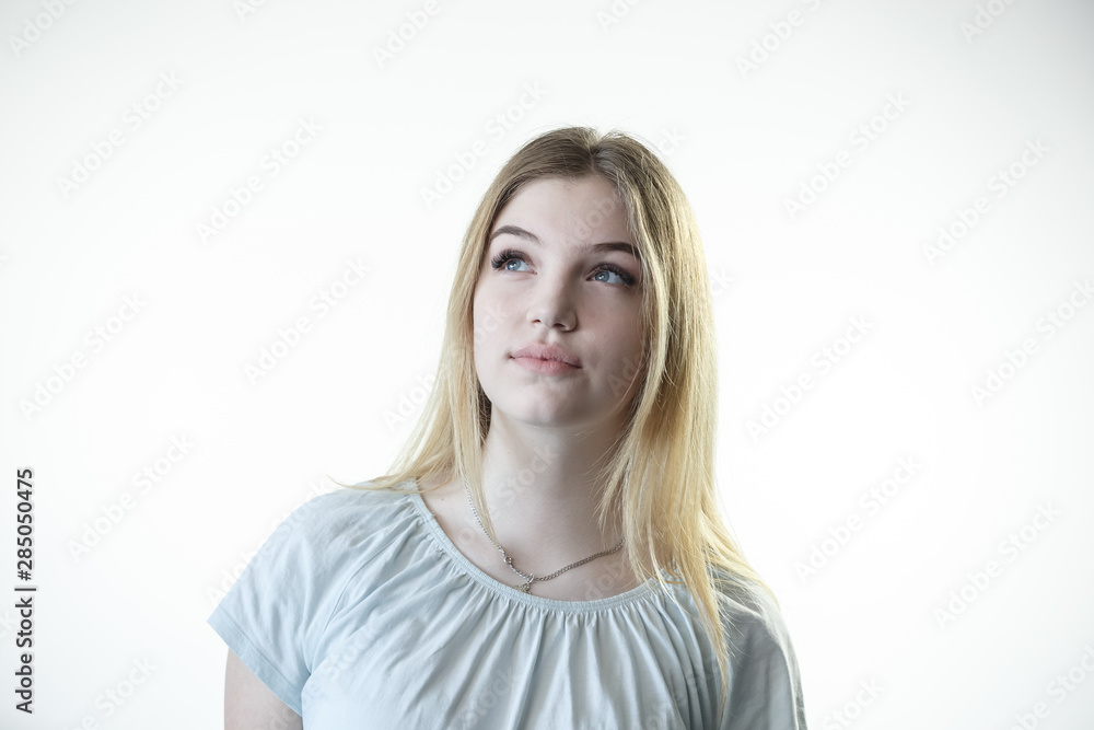 Teenager girl is thinking deciding serious on the white background Teenager girl is thinking deciding serious on the white background