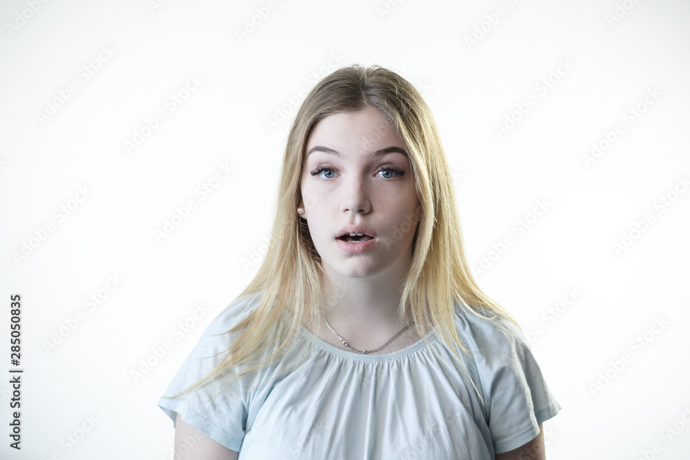 Teenager girl is surprised scared frightened showing emotions on her face Teenager girl is surprised scared frightened showing emotions on her face