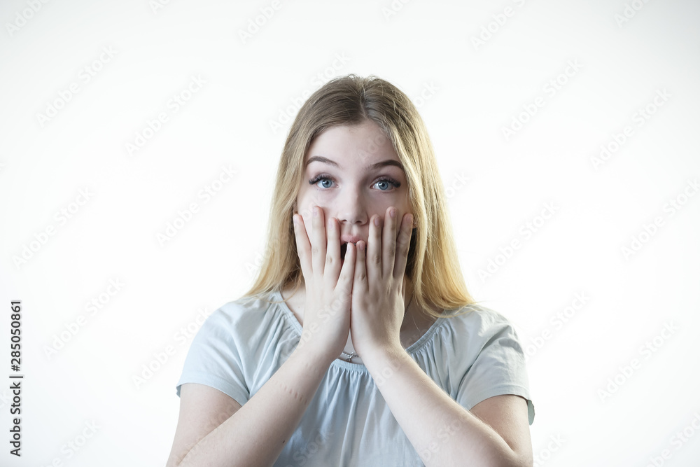 Teenager girl is surprised scared frightened showing emotions on her face Teenager girl is surprised scared frightened showing emotions on her face