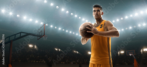 Professional basketball player in sports uniform on basketball court with a ball © TandemBranding
