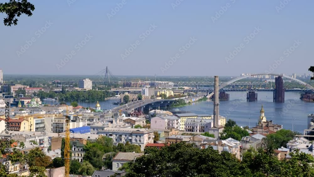 Panoramic video picture cityscape top view of the embankment from the right bank of the Dnieper in Kiev, Ukraine, 08/19/2019 district of the river station, Podil and the bridge under construction, hig