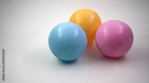 three plastic colorful balls isolated on white background © Desya