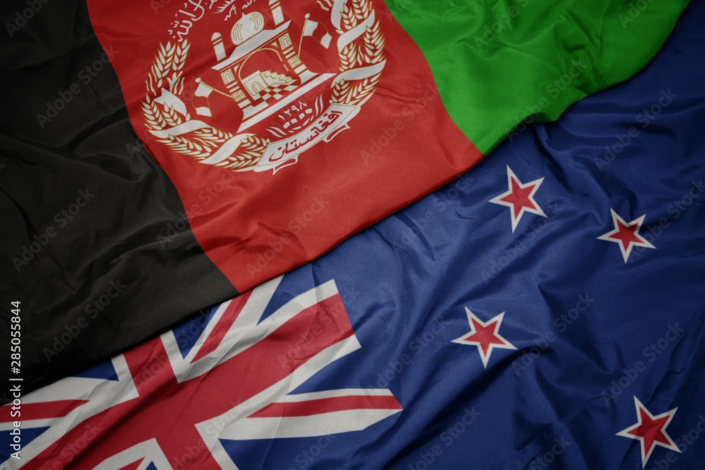 waving colorful flag of new zealand and national flag of afghanistan. waving colorful flag of new zealand and national flag of afghanistan.