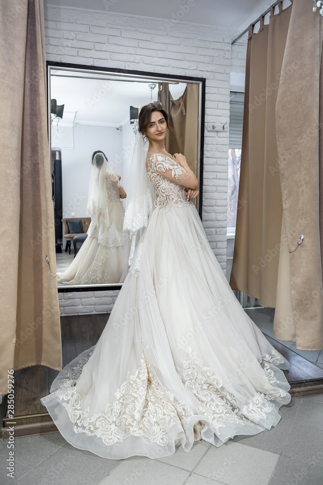 Beautiful young woman posing in wedding dress Beautiful young woman posing in wedding dress