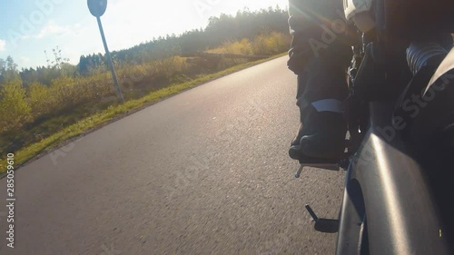 modern scrambler motorbike on the forest road riding. having fun driving the empty road on a motorcycle tour journey.