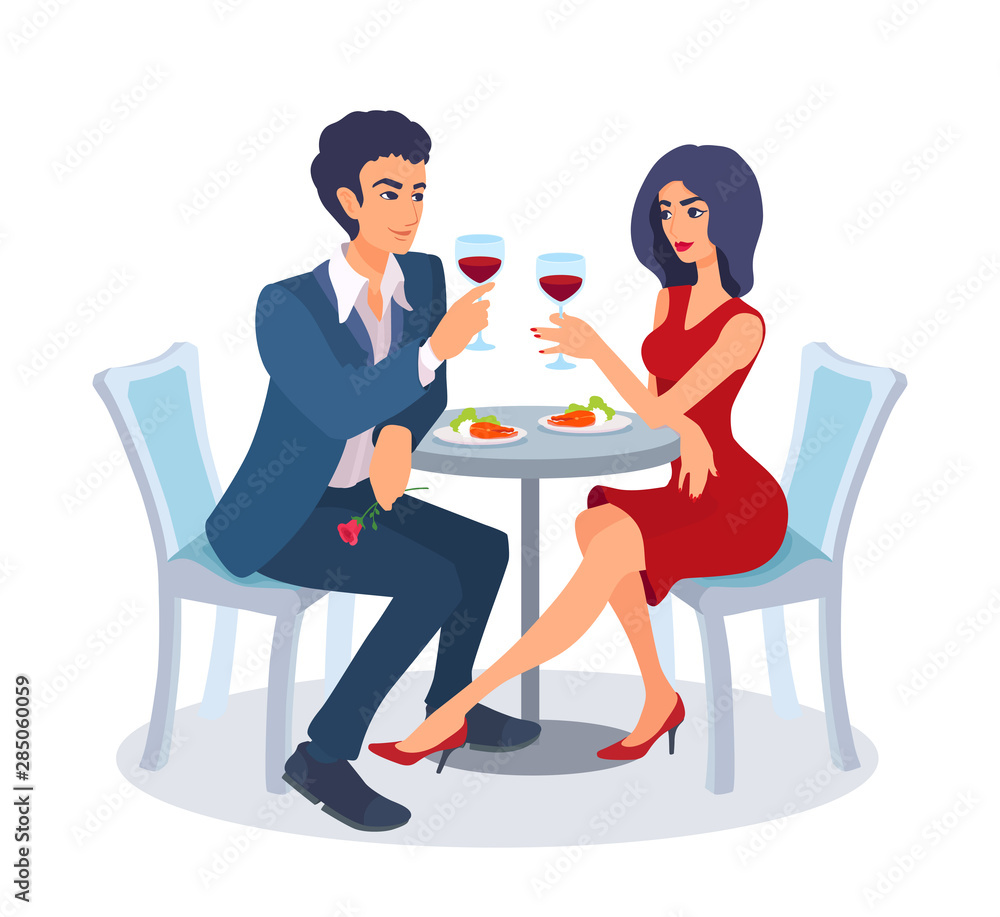 Couple on a date sit together at the table with food, raise their glasses, look at each other. Couple on a date sit together at the table with food, raise their glasses, look at each other.