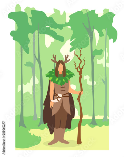 Fototapeta Naklejka Na Ścianę i Meble -  A druid with horn, cape and wooden staff in a forest.