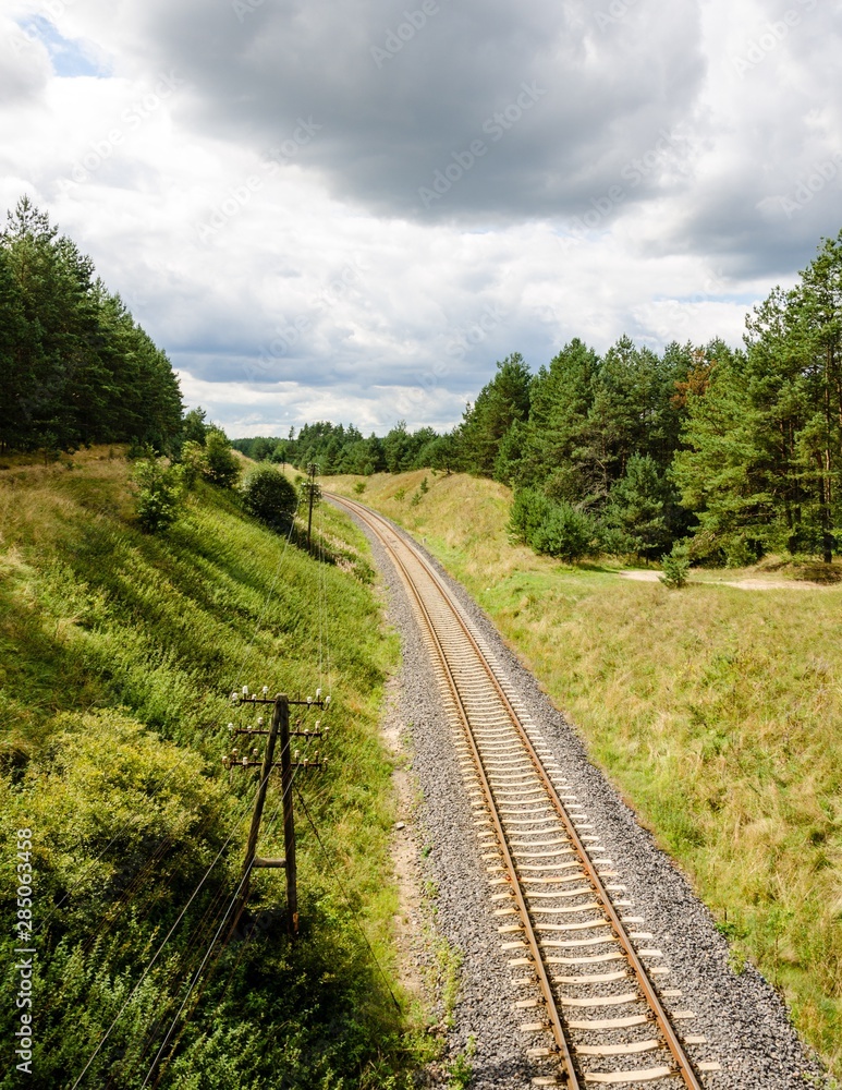 railway tracks crossing green areas