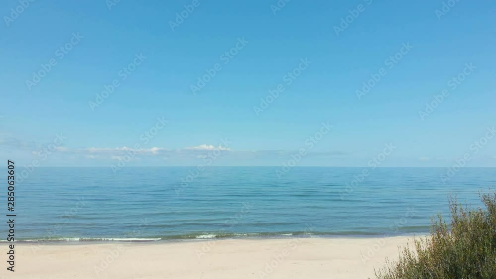 Aerial. Wooden walkway in the sea on beach. Fly over wooden path at Baltic sea over sand dunes with ocean view. 4K UHD. Path to the wide sandy beaches. Aerial. Wooden walkway in the sea on beach. Fly over wooden path at Baltic sea over sand dunes with ocean view. 4K UHD. Path to the wide sandy beaches.
