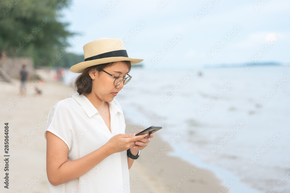 Beautiful young woman holding a smartphone. In order to take a picture of yourself from a camera phone (Selfie). Tourism concept alone Self-portrait photography