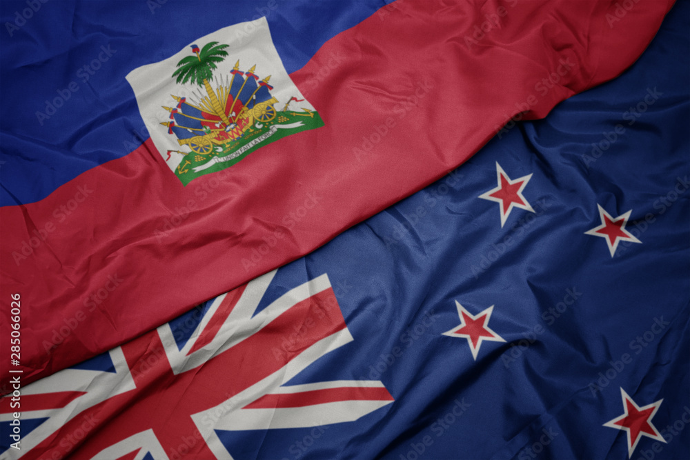waving colorful flag of new zealand and national flag of haiti. waving colorful flag of new zealand and national flag of haiti.