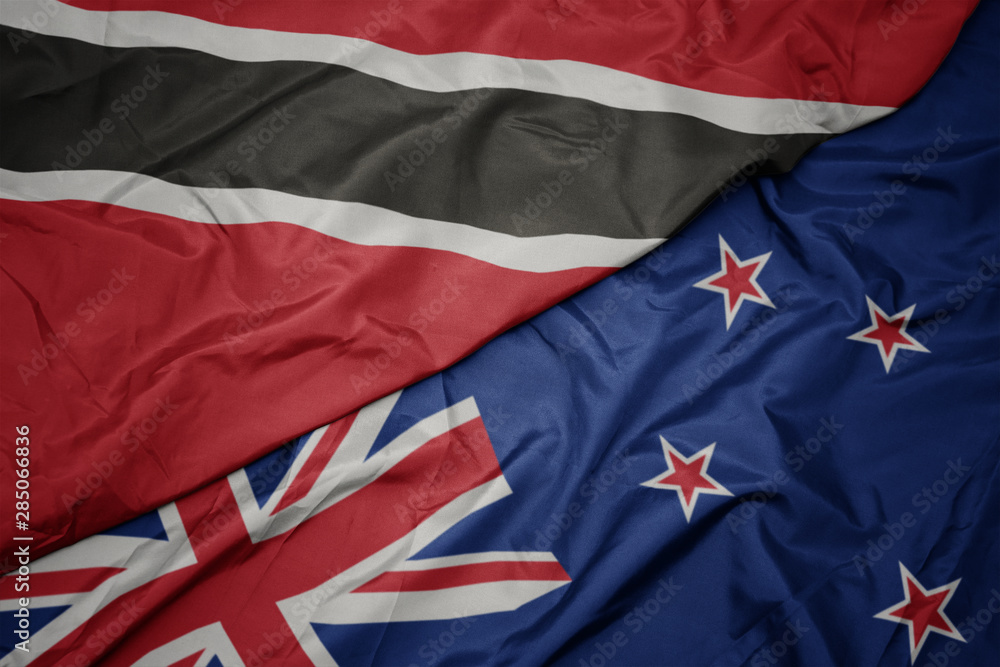 Fototapeta premium waving colorful flag of new zealand and national flag of trinidad and tobago.