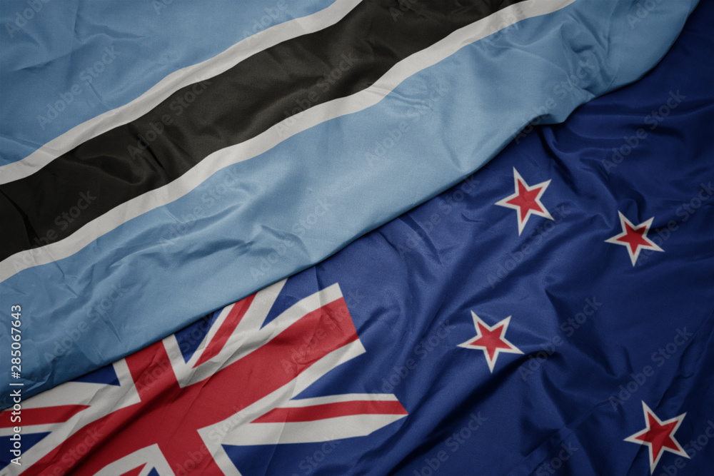 waving colorful flag of new zealand and national flag of botswana. waving colorful flag of new zealand and national flag of botswana.