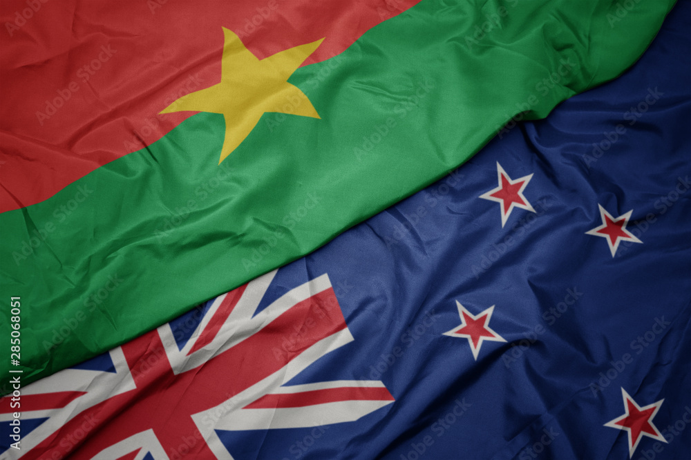 waving colorful flag of new zealand and national flag of burkina faso. waving colorful flag of new zealand and national flag of burkina faso.