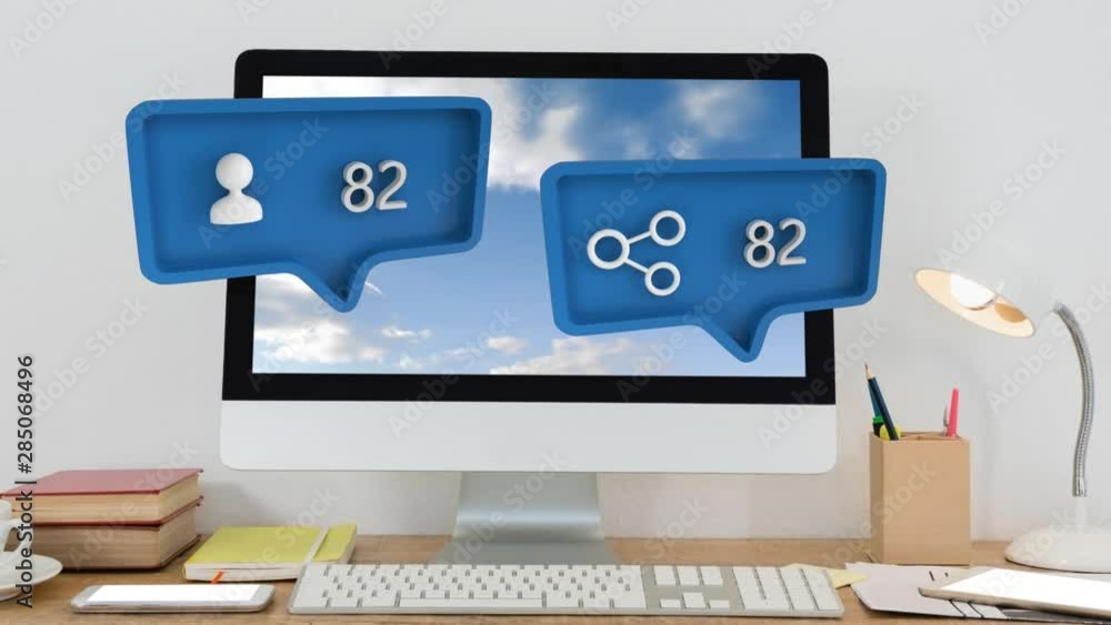 Share and person symbols and increasing numbers over computer, books, lamp on table Share and person symbols and increasing numbers over computer, books, lamp on table