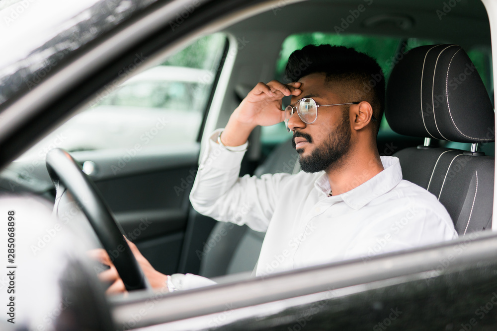 Tired man want sleeps while driving car in traffic