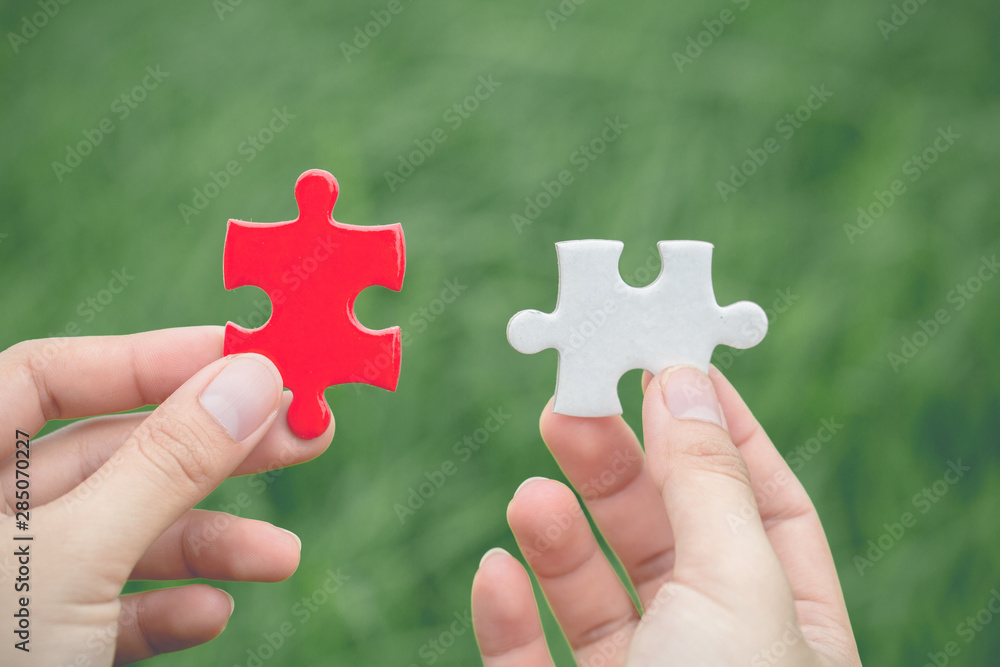 Close up of hands business women connecting jigsaw puzzle, Business Success, Teamwork workplace success and strategy concept.Vintage tone Close up of hands business women connecting jigsaw puzzle, Business Success, Teamwork workplace success and strategy concept.Vintage tone