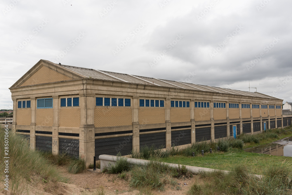 abandoned building warehouse grey sky uk