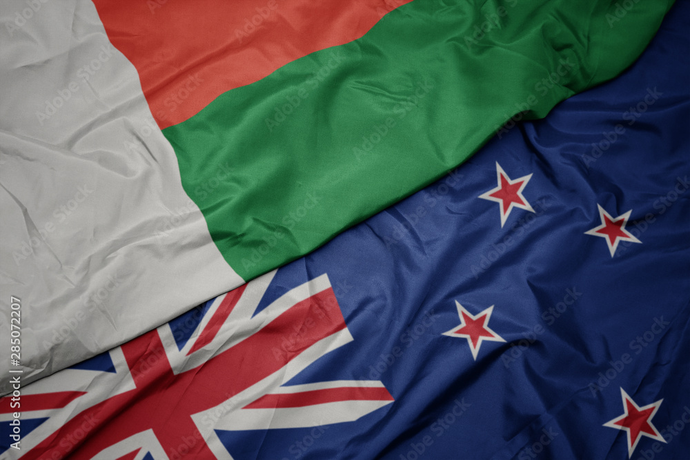 waving colorful flag of new zealand and national flag of madagascar. waving colorful flag of new zealand and national flag of madagascar.