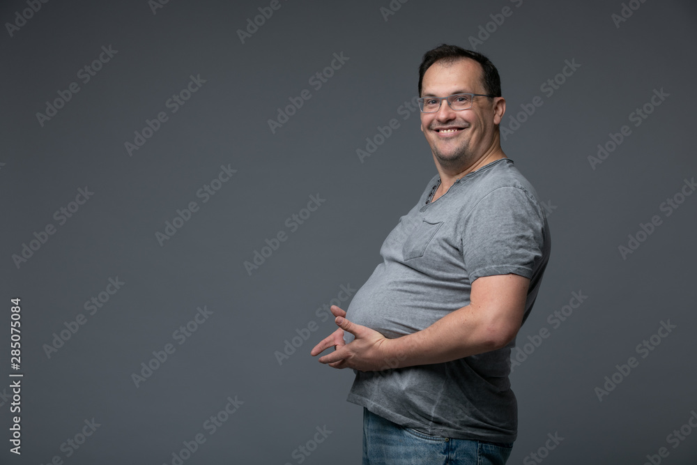 Fat man holds his stomach in his hands Fat man holds his stomach in his hands